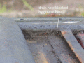 drain hole blocked by accumulation of grease and debris